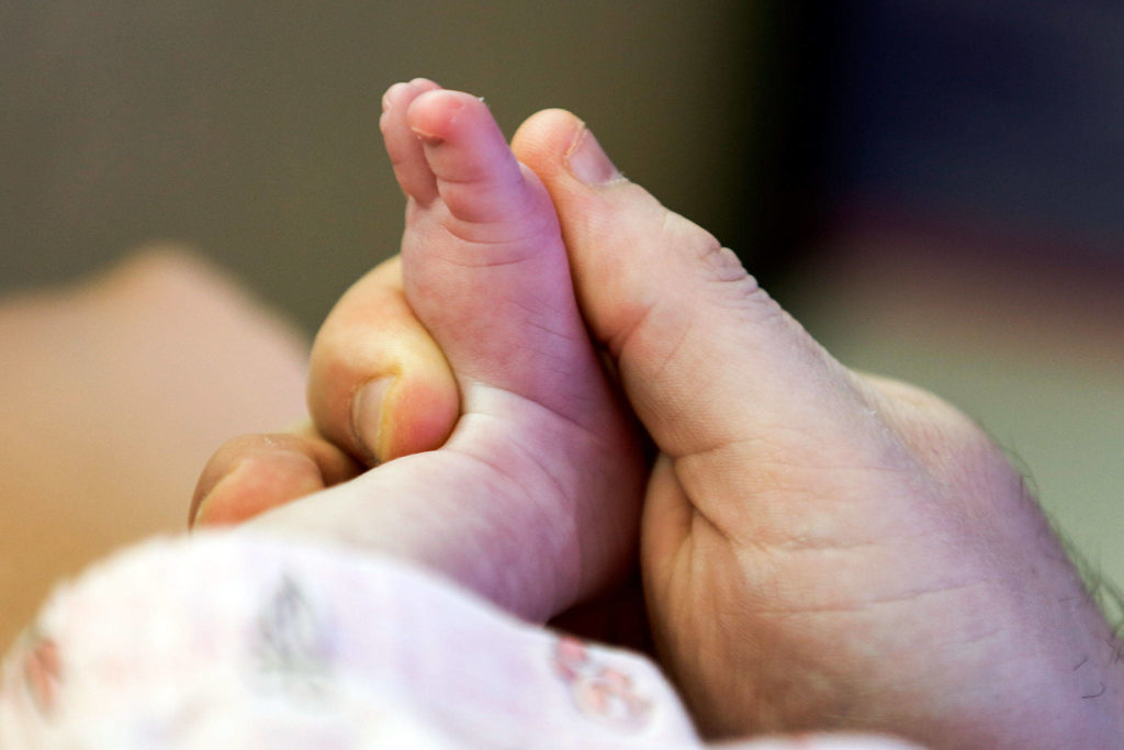 Charlotte Diane Miller with father Josh Miller was born on April 11 at Providence Pavilion for Women and Children because Swedish Edmonds baby unit was closed due to COVID-19. (Kevin Clark / The Herald)
