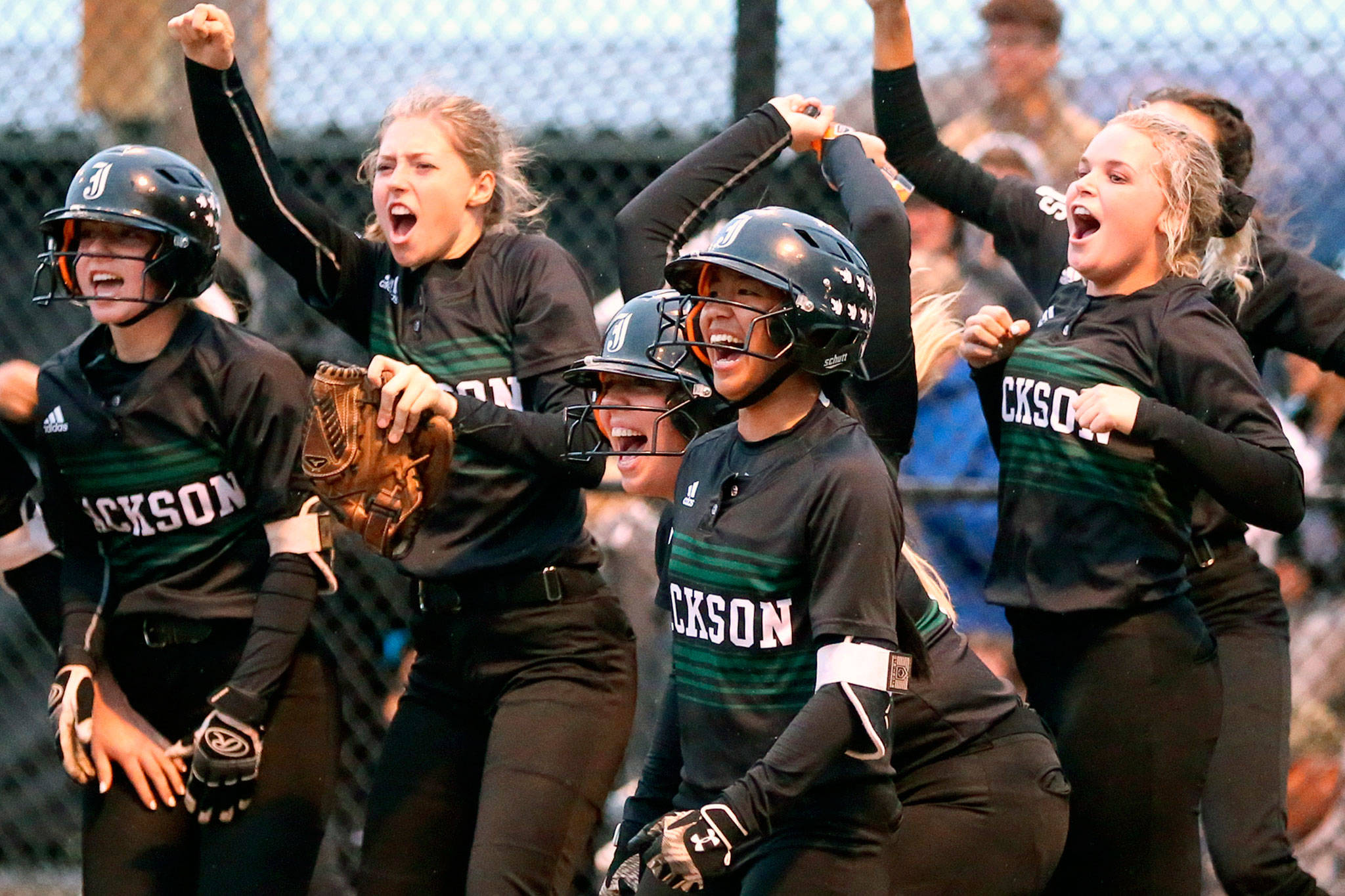 (Left-to-right) Jackson’s Kelsey DeFries, Macy Tarbox, Amanda Wingert, Jessica Asantor and Sam Warren celebrates a home run during a game against Lake Stevens on May 15, 2019, in Everett. (Kevin Clark / The Herald)