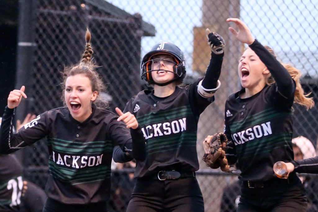 Jackson’s Julia Dillon (left), Kelsey DeFries (center) and Macy Tarbox celebrate a home run during a game against Lake Stevens on May 15, 2019, in Everett. (Kevin Clark / The Herald)
