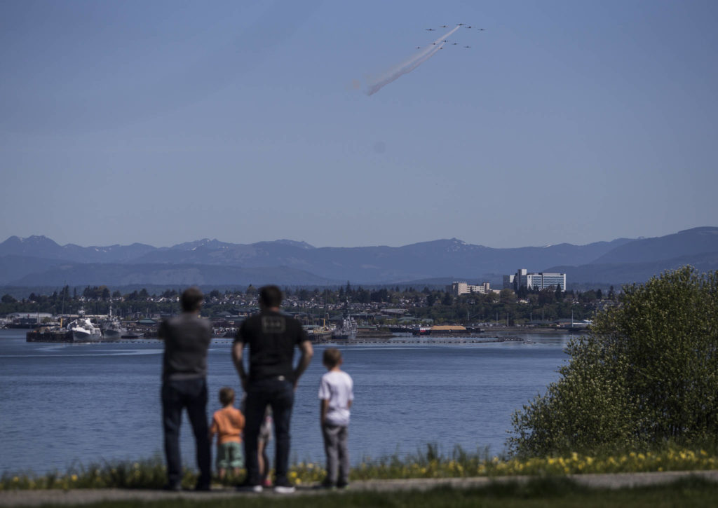 The Huff family watches as the Cascade Warbirds fly over Everett for their V-E Day Remembrance Flight at Harborview Park on May 8, 2020 in Everett. (Olivia Vanni / The Herald)
