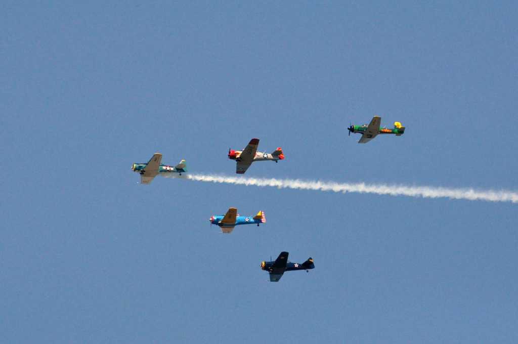 The Cascade Warbirds fly over Naval Station Everett on Friday. (Sue Misao / The Herald)
