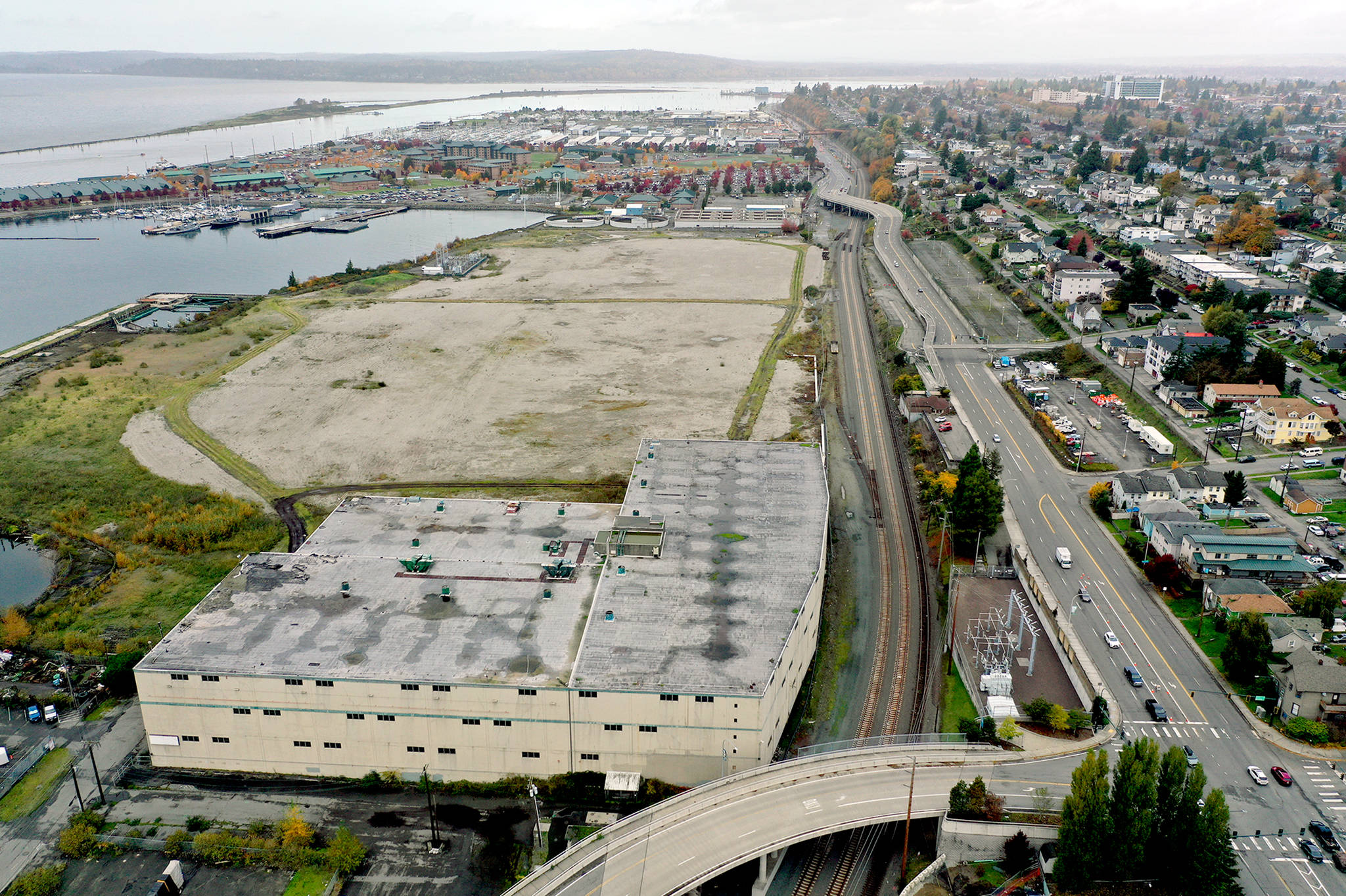 The warehouse (lower left) and vacant land of the former Kimberly-Clark paper mill on the Everett waterfront, as seen Oct. 23, 2019. (Chuck Taylor / Herald file)