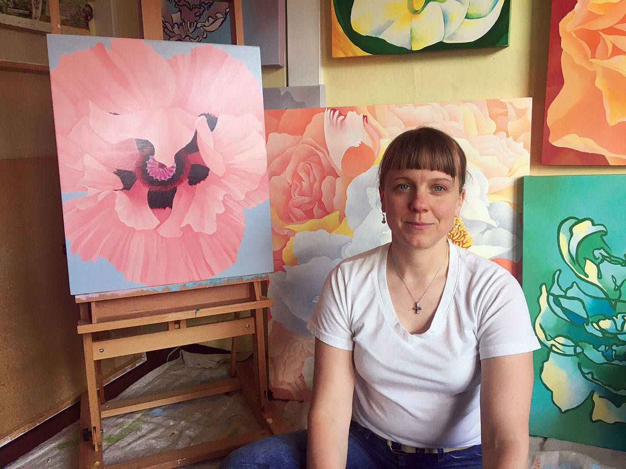 Kimberly Mattson paints out of a studio at her Everett home, where she hung all the paintings that were intended for exhibits that were canceled because of the pandemic. (Joshua Mattson)