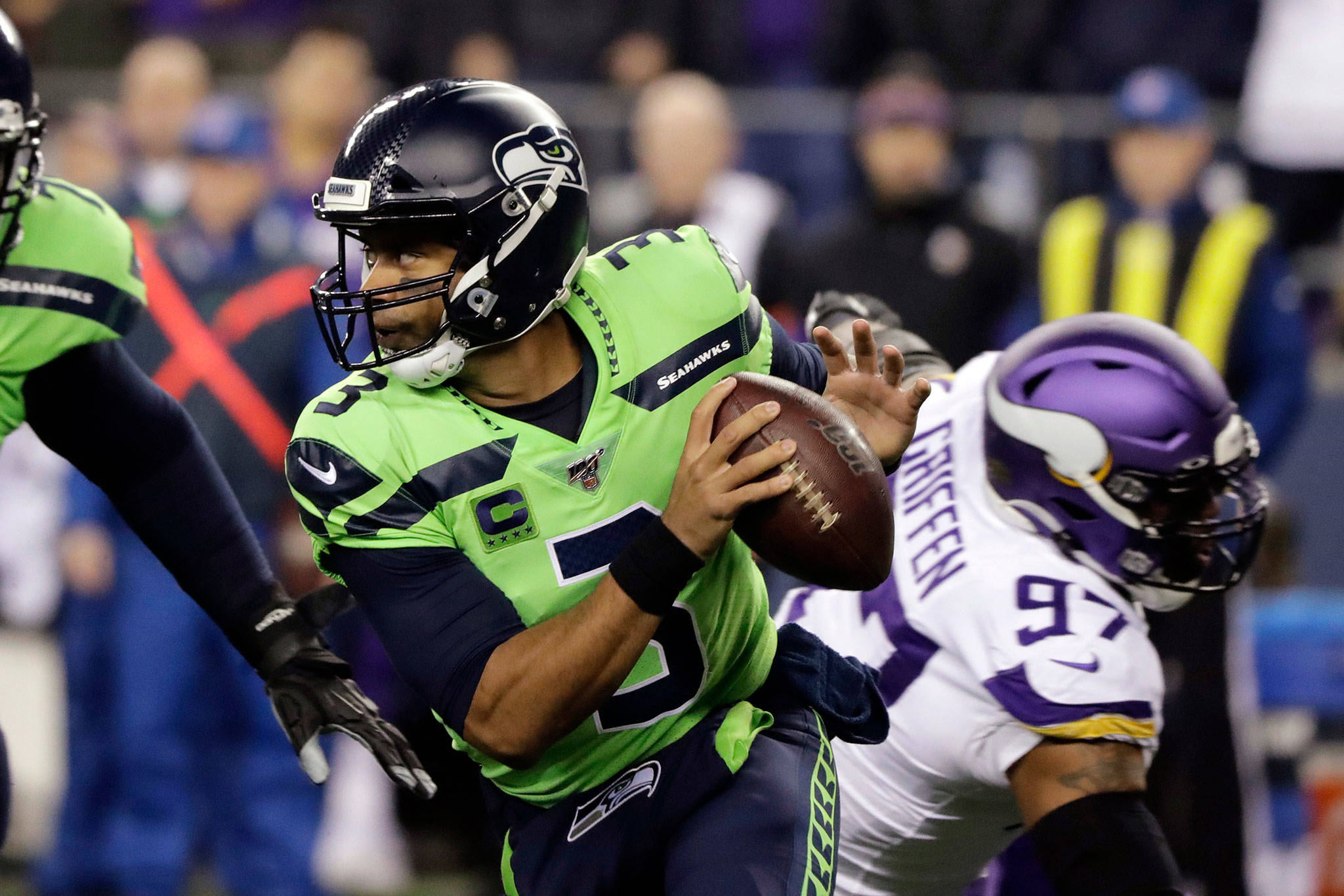 Seahawks quarterback Russell Wilson scrambles against the Vikings during the first half of a Monday Night Football game on Dec. 2, 2019, in Seattle. (AP Photo/Ted S. Warren)