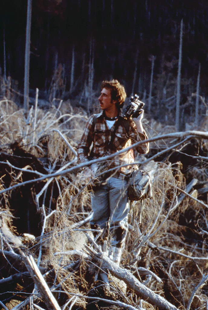 Days after Mount St. Helens erupted 4 years ago, Michael Lienau, then 20, enters the blast zone as part of a film crew. (Russell Johnson photo)
