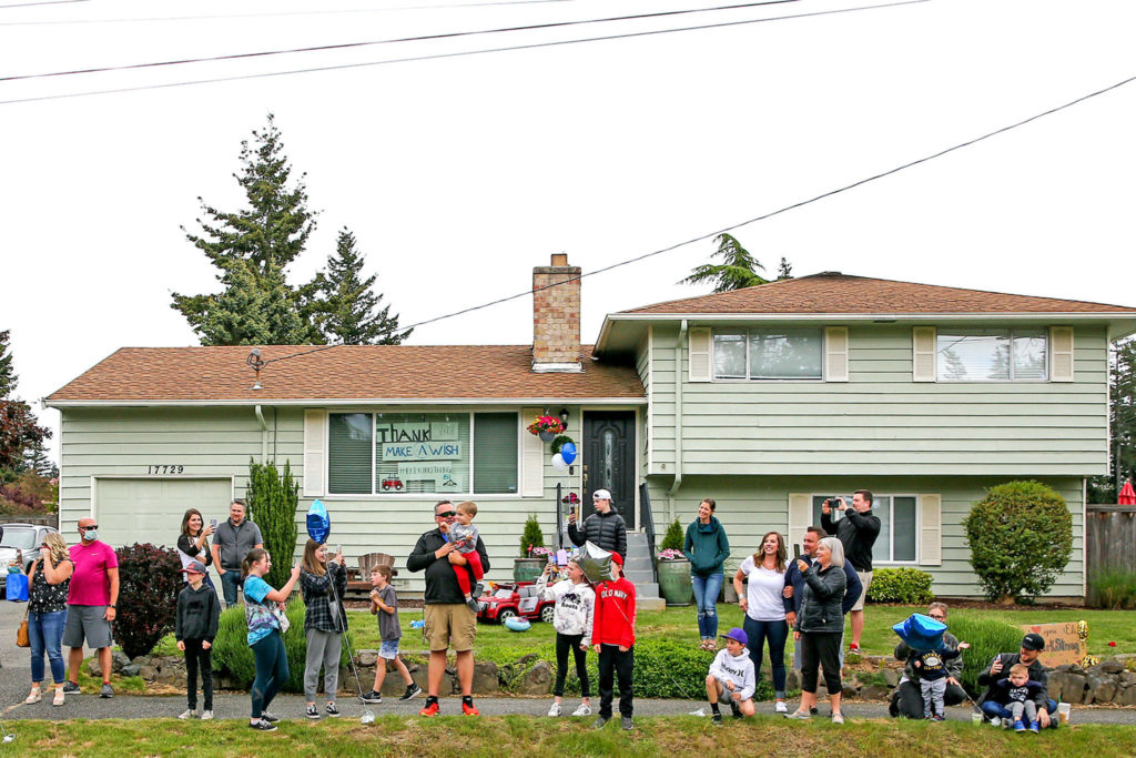 Friends and family gather for Eli Kincaid’s Make-A-Wish parade of first responders. Eli has Alexander disease, a rare genetic disorder. (Kevin Clark / The Herald)
