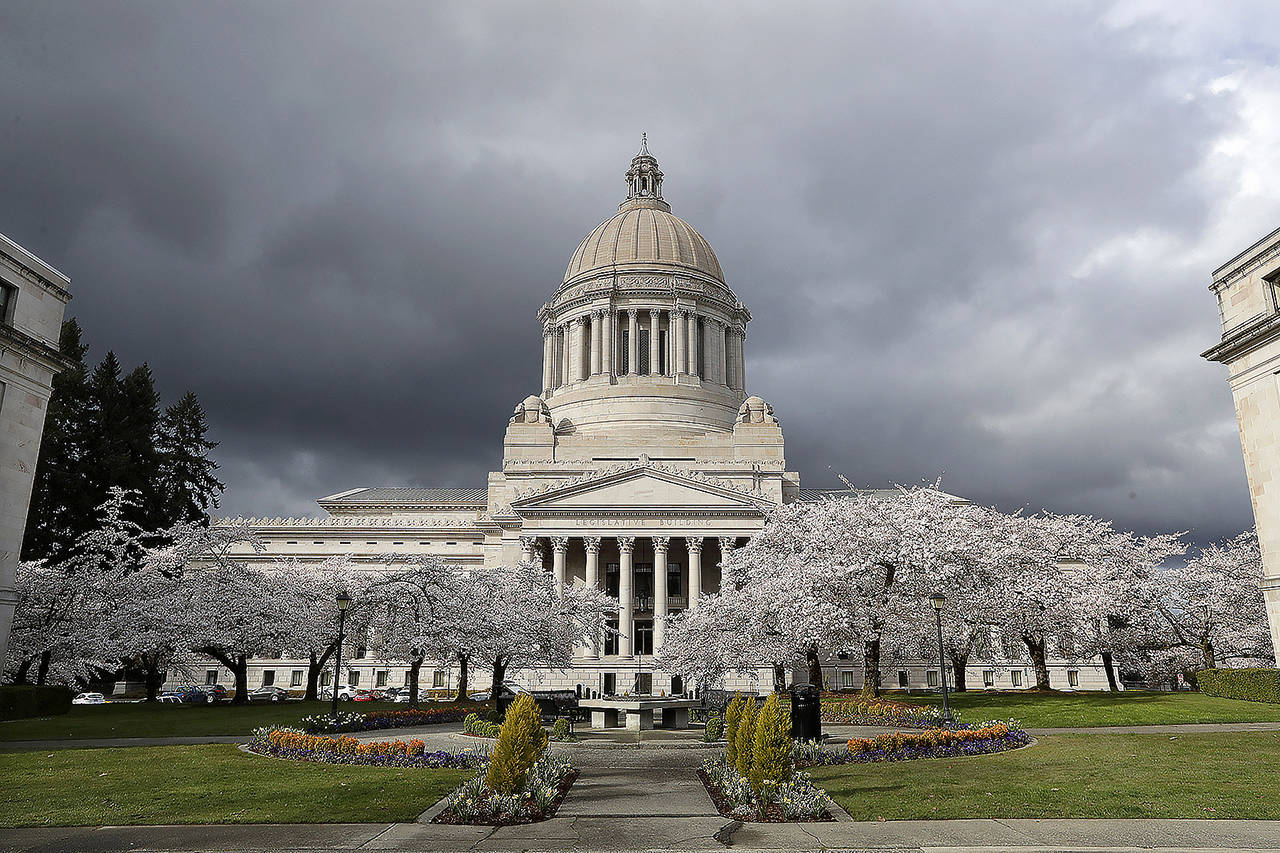 The Capitol building in Olympia. Even once Washington’s economy fully reopens following the coronavirus outbreak, the effect on state revenues is expected to be felt for months and maybe years to come, leading state officials to start preparing for inevitable budget cuts now. (AP Photo/Elaine Thompson)