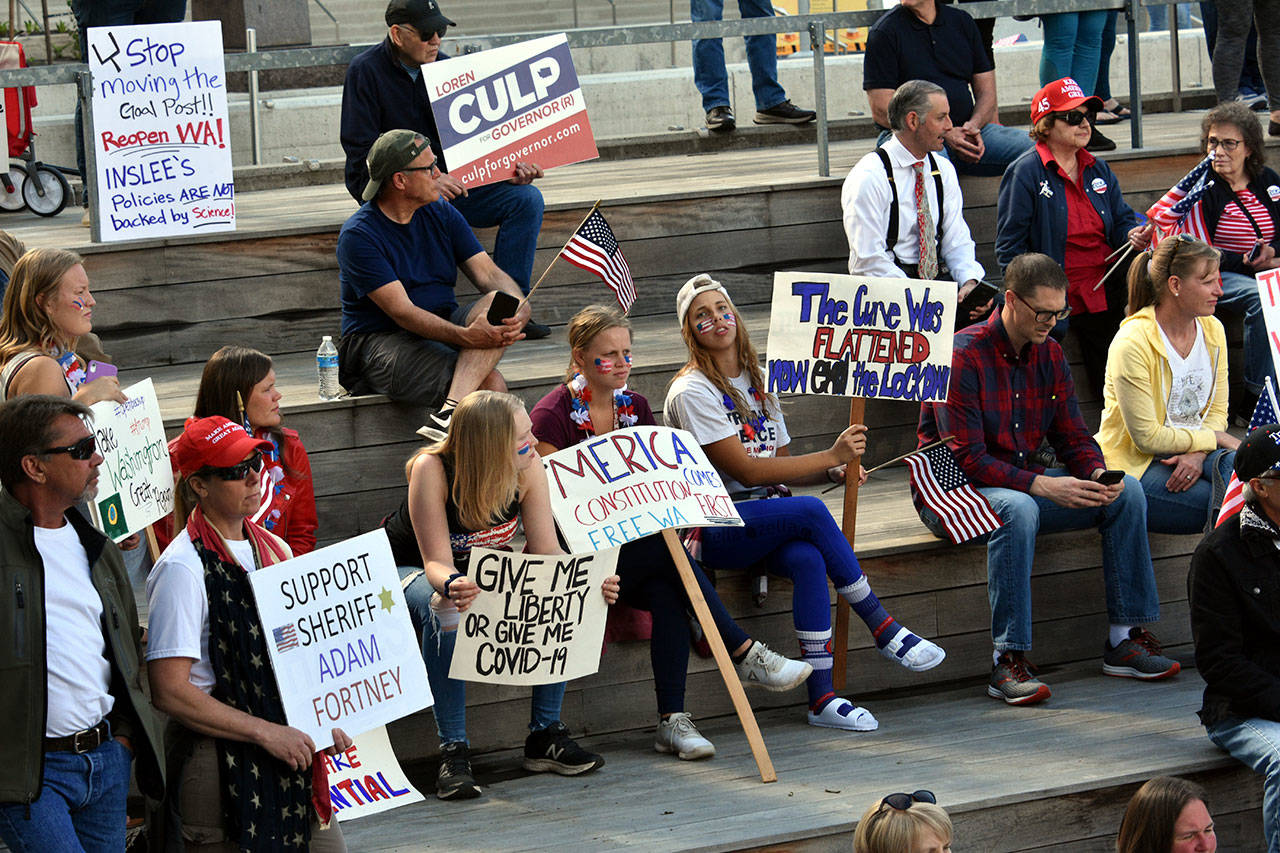 About 200 protestors gathered outside the Snohomish County Courthouse on Friday to voice opposition to Gov. Jay Inslee’s stay-at-home order. (Caleb Hutton / The Herald)
