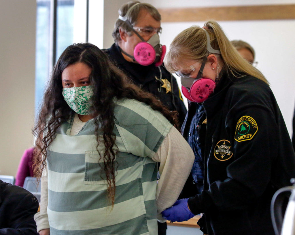 Lendsay Meza is handcuffed after being to sentenced to 50 years for the 2018 torture and killing of two men Thursday afternoon at the Snohomish County Courthouse in Everett. (Kevin Clark / The Herald)
