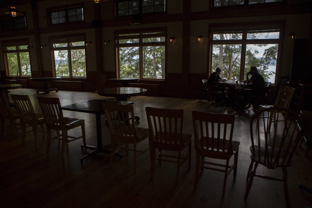 Cafe owner Donna King meets with manager Chad Allen at the restaurant’s cordoned-off dining room. (Olivia Vanni / The Herald)
