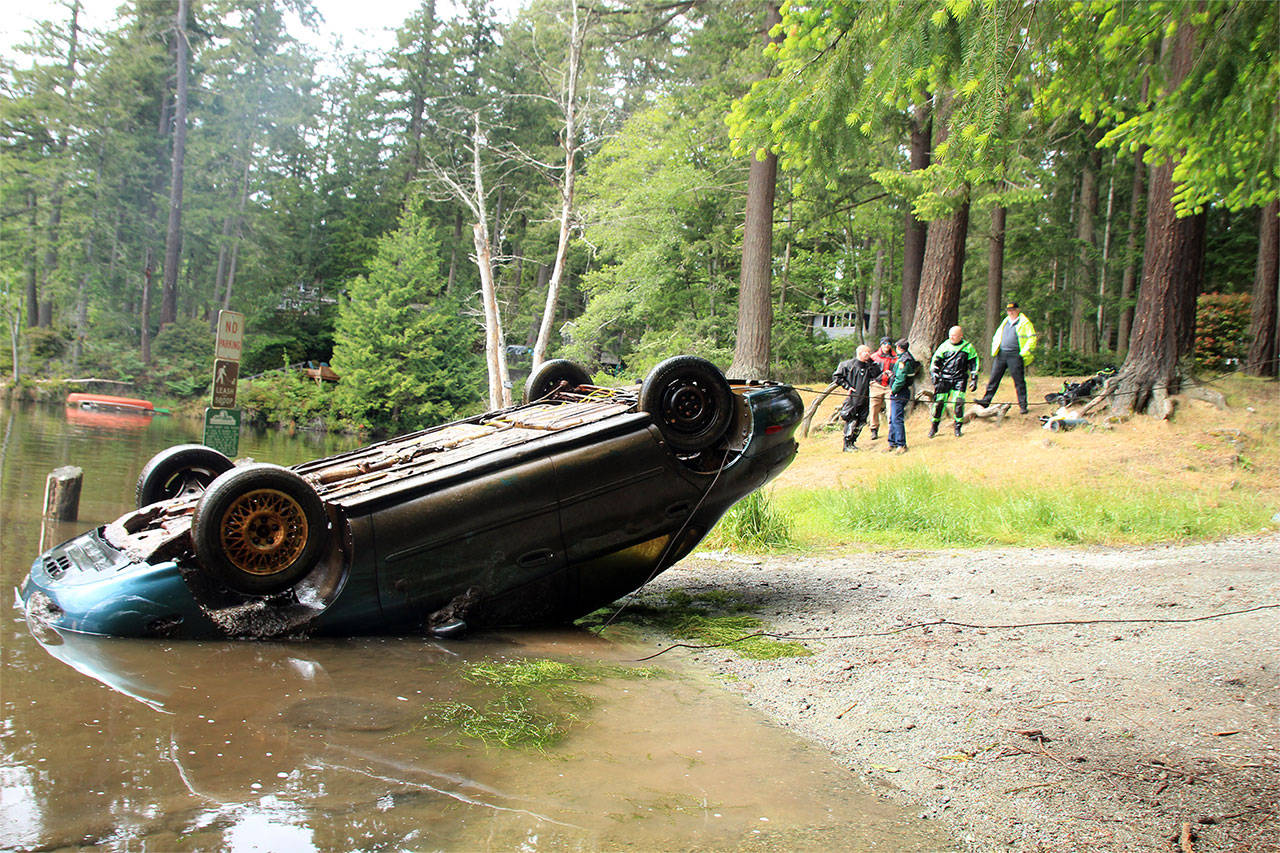A Ford Taurus was pulled from the muddy depths of Goss Lake on May 21. (Whidbey News-Times)