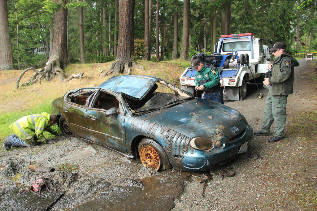 A Ford Taurus was pulled from the muddy depths of Goss Lake on May 21. (Whidbey News-Times)
