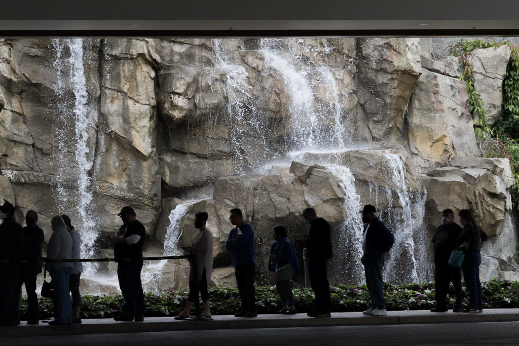 Customers wait in line to enter the Tulalip Resort Casino as it reopens Tuesday. (Andy Bronson / The Herald) 
