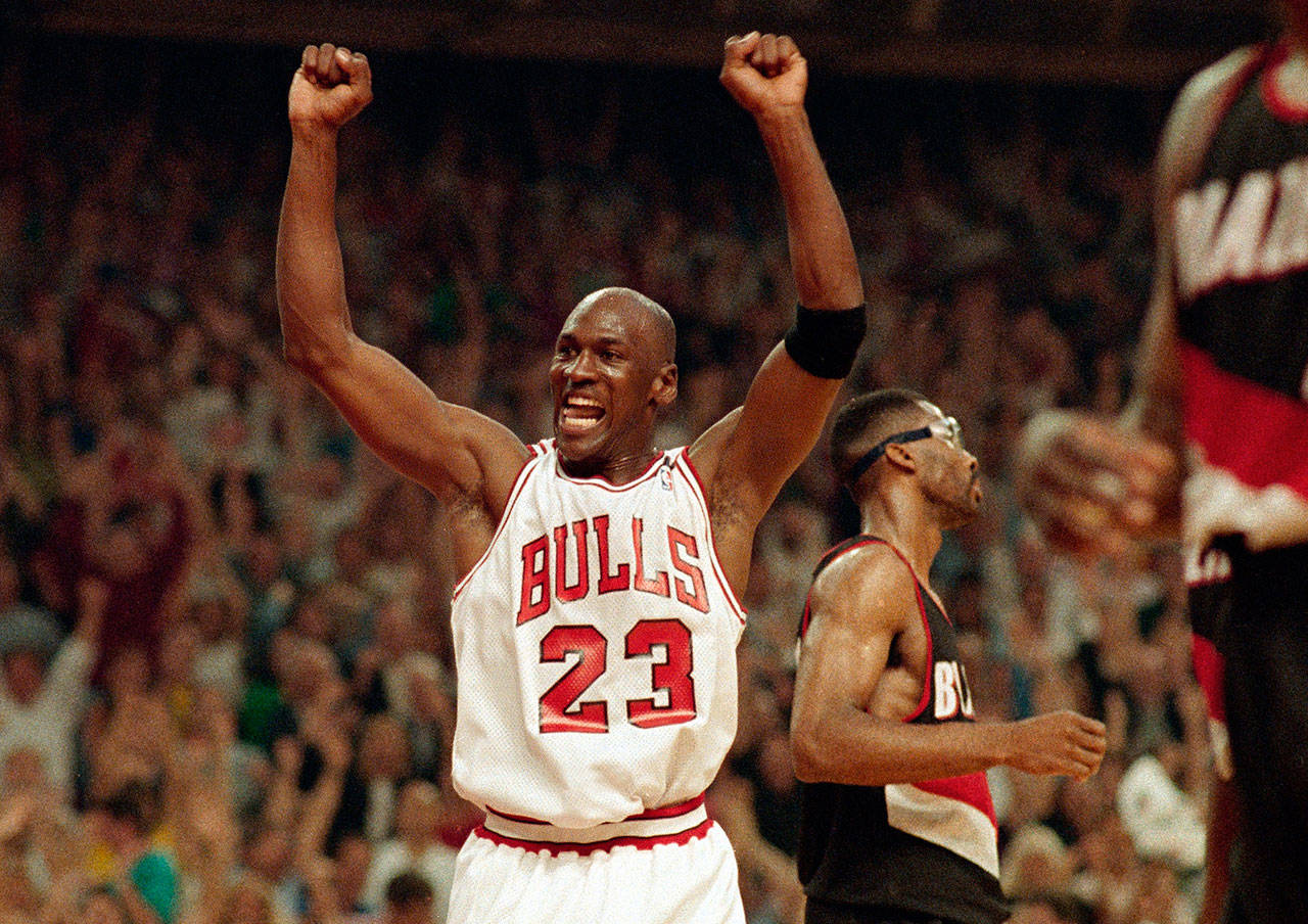 Michael Jordan celebrates the Bulls win over the Trail Blazers in the NBA finals on June 14, 1992, in Chicago. (AP Photo/John Swart)