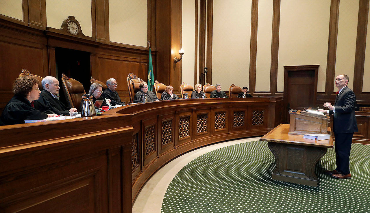 Joel Ard (right), shown here speaking before the Washington Supreme Court in Olympia on June 28, 2018, is the attorney for a group challenging the constitutionality of Gov. Jay Inslee’s stay-at-home order. (AP Photo/Ted S. Warren file)