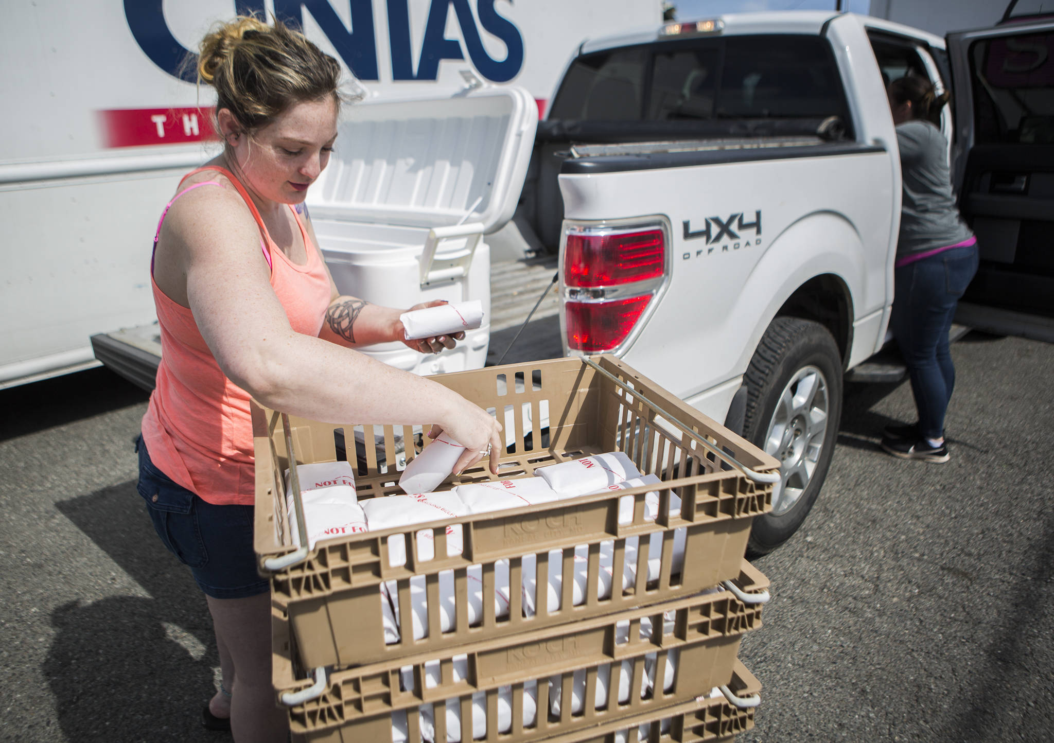 Emma Perkins loads her share of a full cow into a cooler in the back of her truck outside of Silvana Meats on Friday, May 29, 2020 in Silvana, Wa. (Olivia Vanni / The Herald)