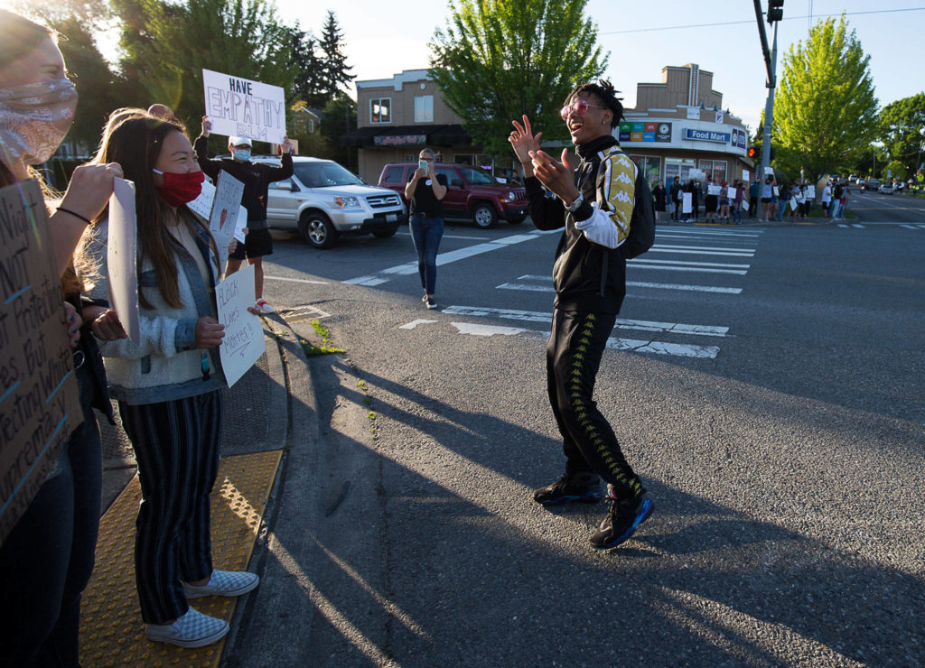 Justice Jackson, of Marysville, thanks supporters as they protest at corners of 2nd and D St in Snohomish on Monday. (Andy Bronson / The Herald)
