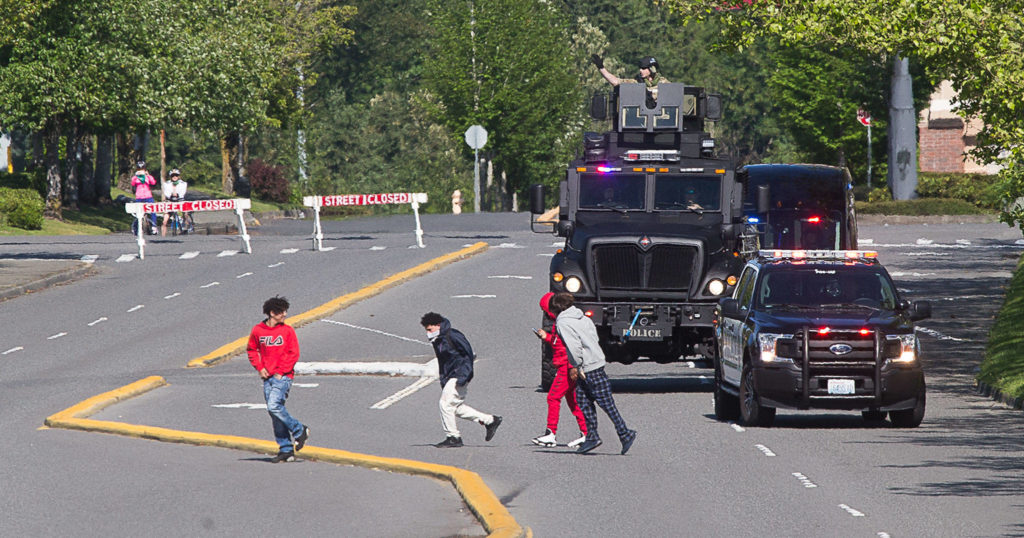 Law enforcement officers tell people to go home as a curfew went into effect near the Alderwood mall on Monday in Lynnwood. (Andy Bronson / The Herald)
