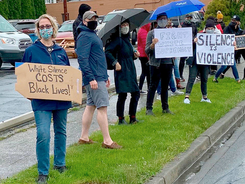 People hold and wave signs Saturday during Snohomish For Equity’s rally for racial justice on Avenue D in Snohomish. The group estimated 400 people took part for the hour-long demonstration. (Snohomish For Equity)
