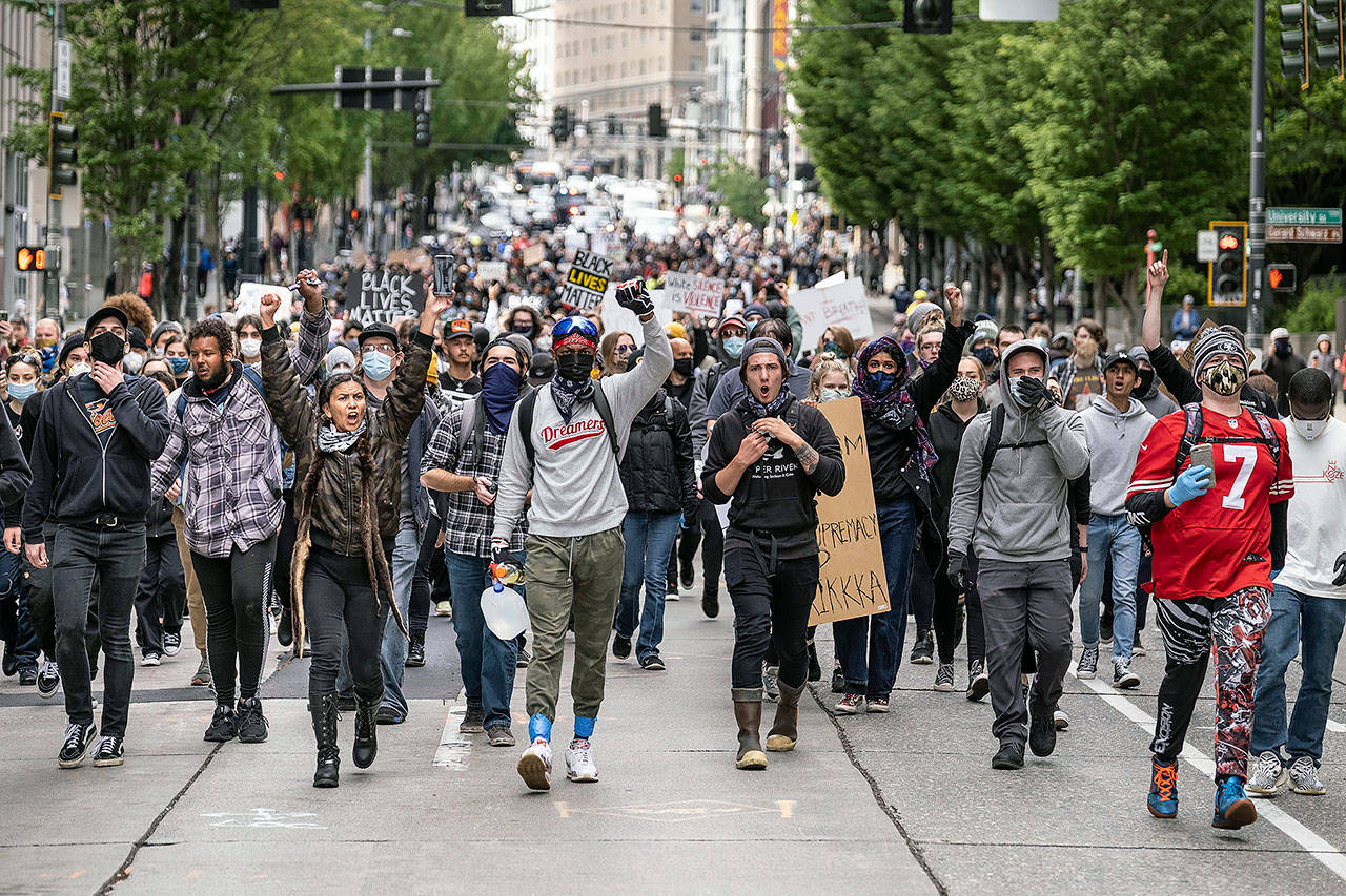 Protestors move south on Second Avenue in Seattle on Sunday. (Ken Lambert/The Seattle Times via AP)