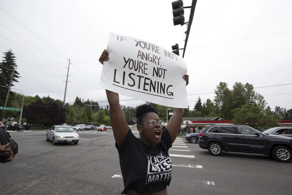 Olivia Craven cheers on about two hundred protesters at the intersection of 164th Street and the Bothell-Everett Highway, to protest the killing of George Floyd, on Tuesday, June 2, 2020 in Mill Creek, Wa. (Andy Bronson / The Herald)
