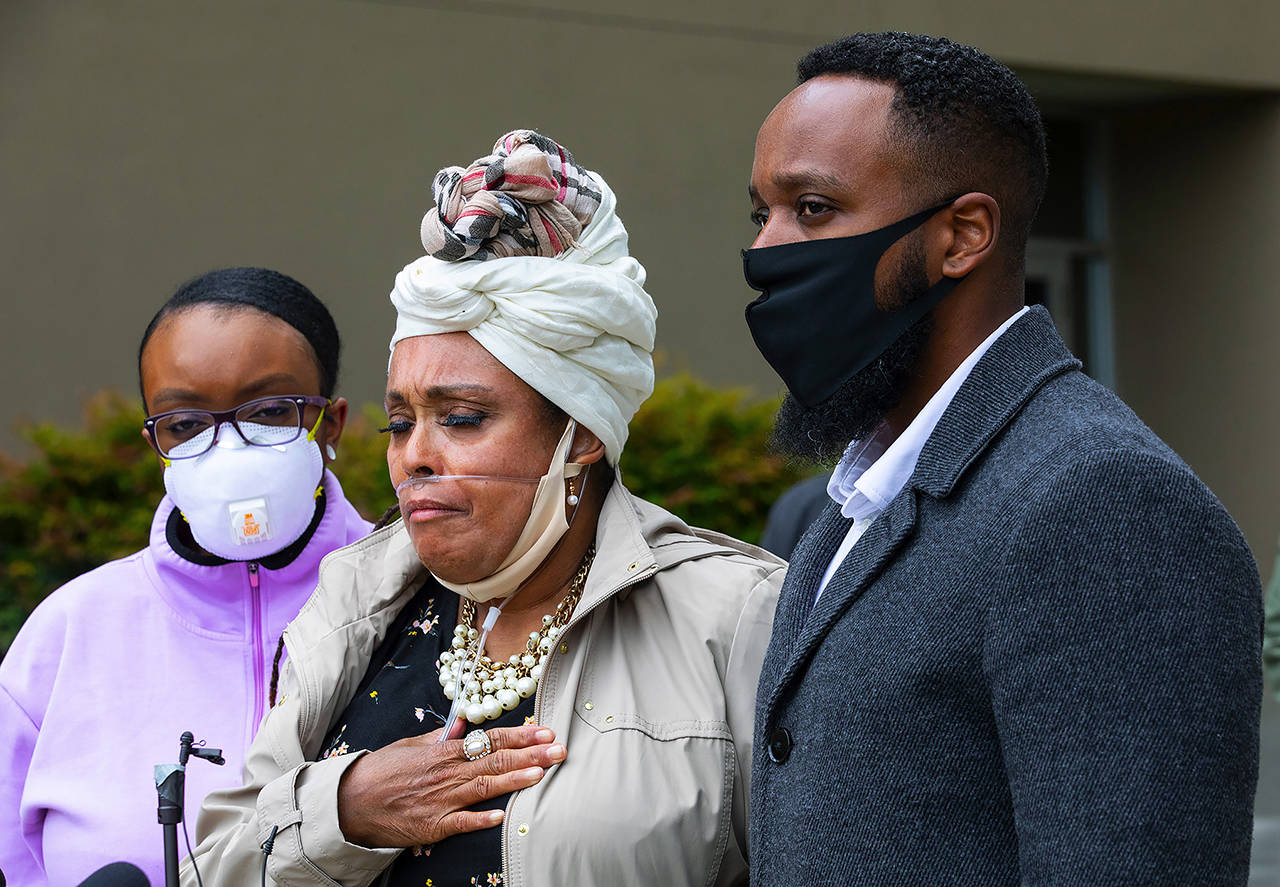 Marcia Carter-Patterson (center), mother of Manny Ellis, speaks at a press conference in front of the Pierce County Superior Court in Tacoma on Thursday regarding the killing of her son by Tacoma police. At left is Manny’s sister Monet Carter-Mixon and at right is his brother Matthew Ellis. (Ellen M. Banner/The Seattle Times via AP)
