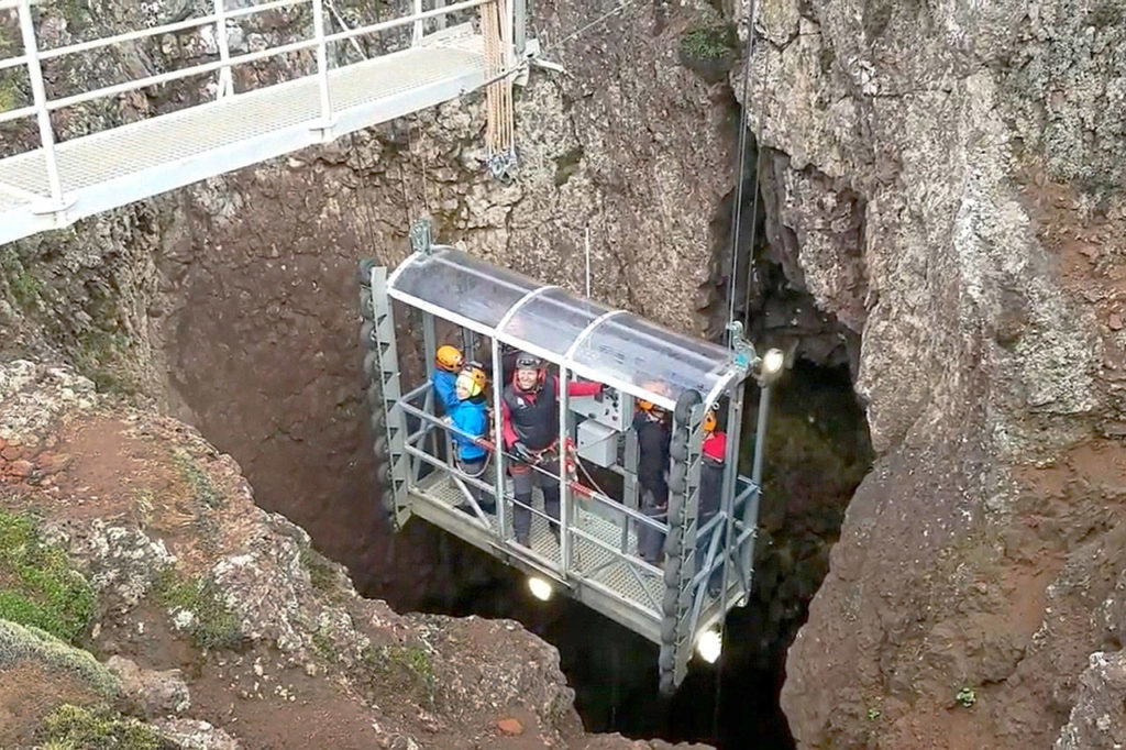 A lift lowers visitors on the “Inside the Volcano” tour 400 feet down into a vast, colorful chamber in the dormant Thrihnukagigur volcano. (Rick Stevs’ Europe)
