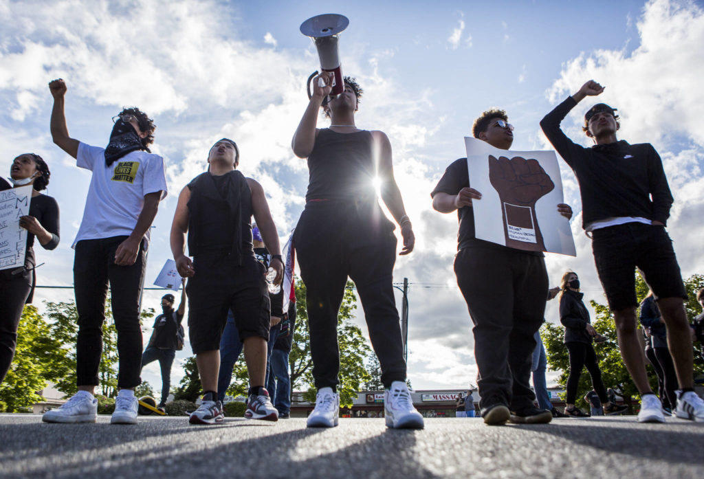Bilal Jaddi (left to right), Christian Ayson, Keyshon Rife, Daniel Jenkins and Cameron Asinsin lead the crowd in chants as they arrive at the park lot along 84th Street and Mukilteo Speedway during the Black Lives Matter protest on Sunday in Mukilteo. (Olivia Vanni / The Herald)

