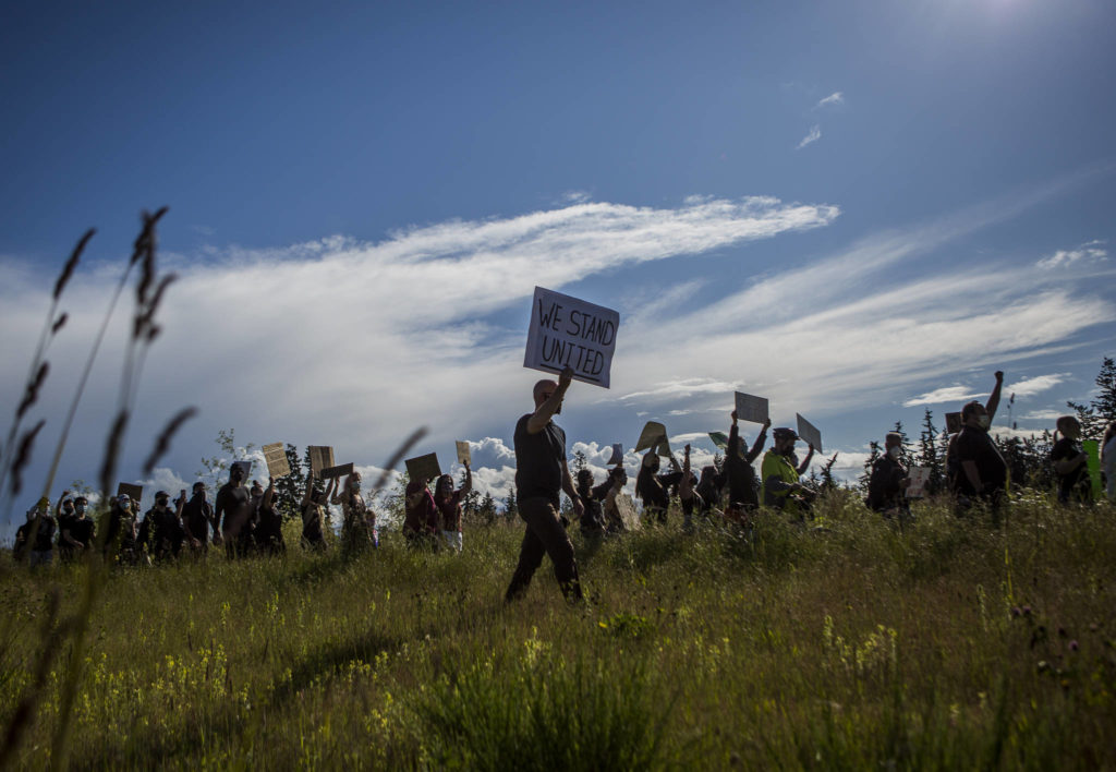 Protesters walk along Mukilteo Speedway during the Black Lives Matter protest on Sunday in Mukilteo. (Olivia Vanni / The Herald)
