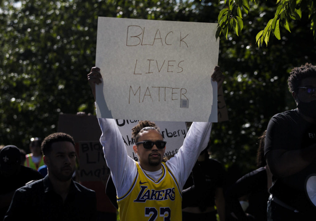 Caleb Perry holds a Black Lives Matter sign during the Black Lives Matter protest on Sunday in Mukilteo. (Olivia Vanni / The Herald)
