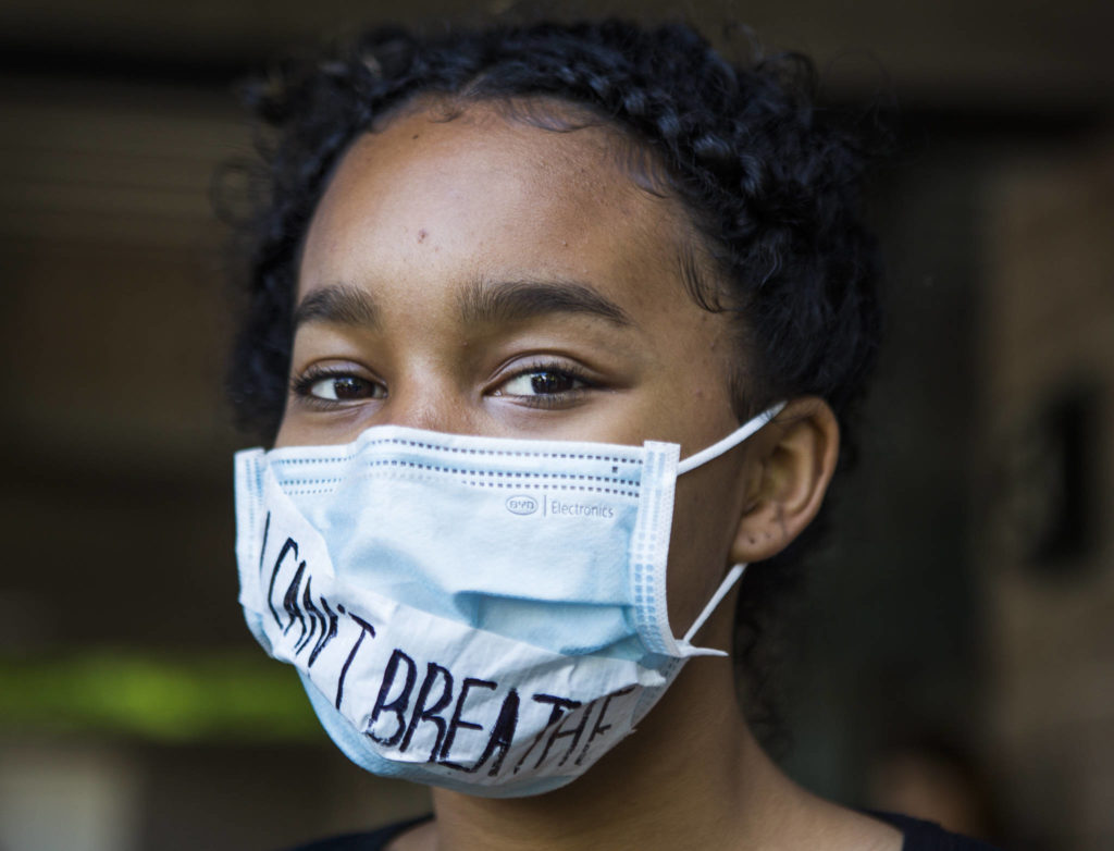 Orlaan Winston wears a mask with the phrase “I Can’t Breathe” across it during the Black Lives Matter protest on Sunday in Mukilteo. (Olivia Vanni / The Herald)
