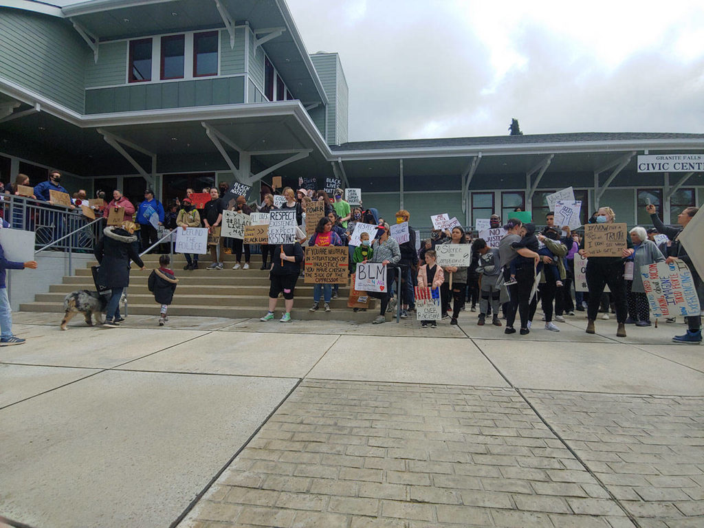 Black Lives Matter protestsrs stand on the steps of Granite Falls City Hall on Sunday. (Zac Hereth / The Herald)
