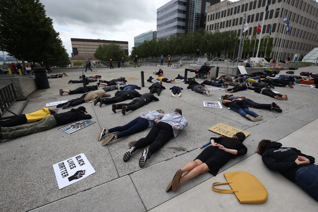 At least 100 people gathered Monday to protest the killing of George Floyd, and to call on the Snohomish County Council to partially defund the Snohomish County Sheriff’s Office. (Andy Bronson / The Herald)
