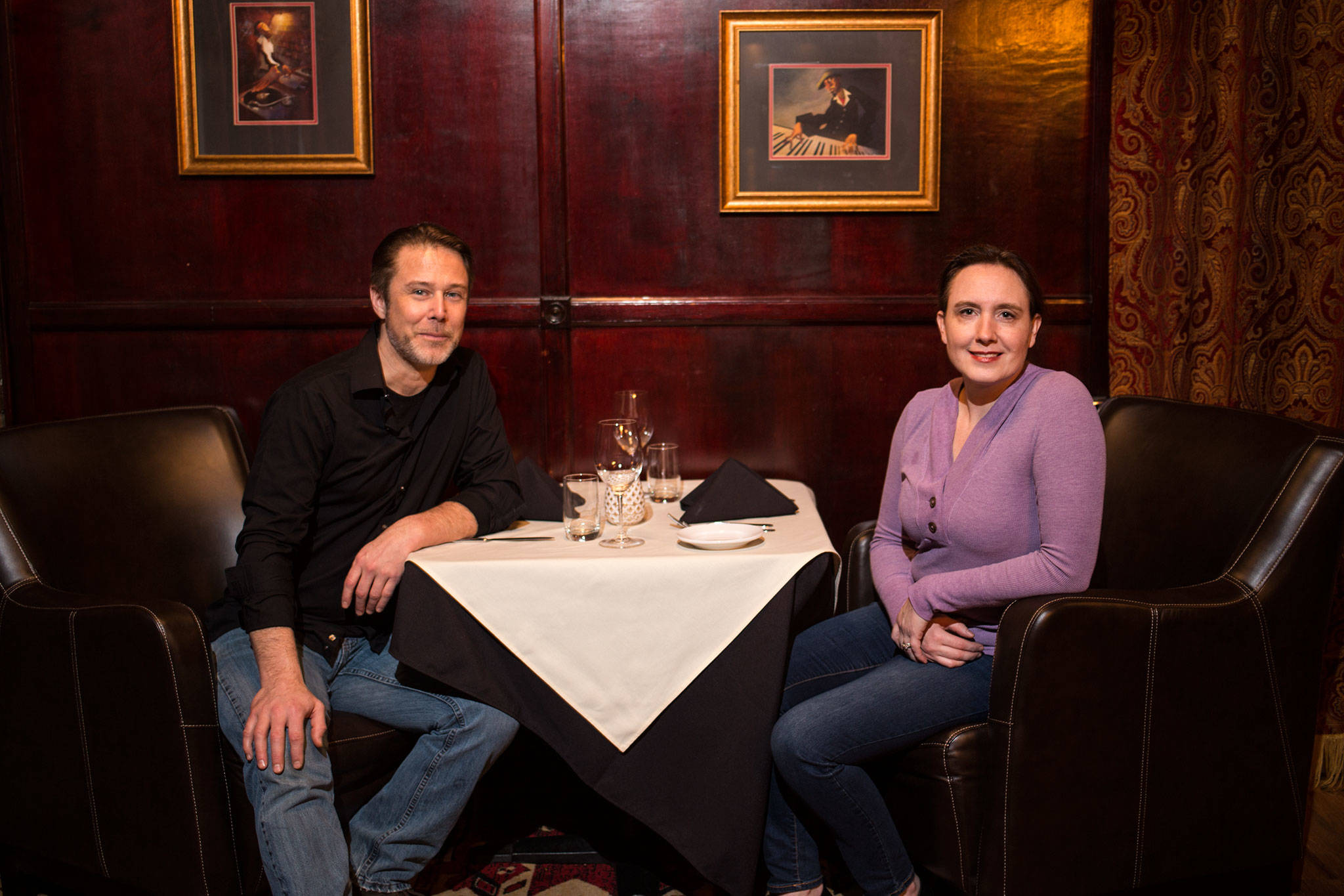 James and Anne Abbott, owners of Abbott’s, sit in brown leather club chairs in the back room. (Andy Bronson / The Herald)