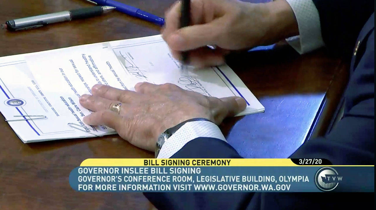 Gov. Jay Inslee signs Senate Bill 5395, which allows comprehensive sexual education in schools. (TVW)