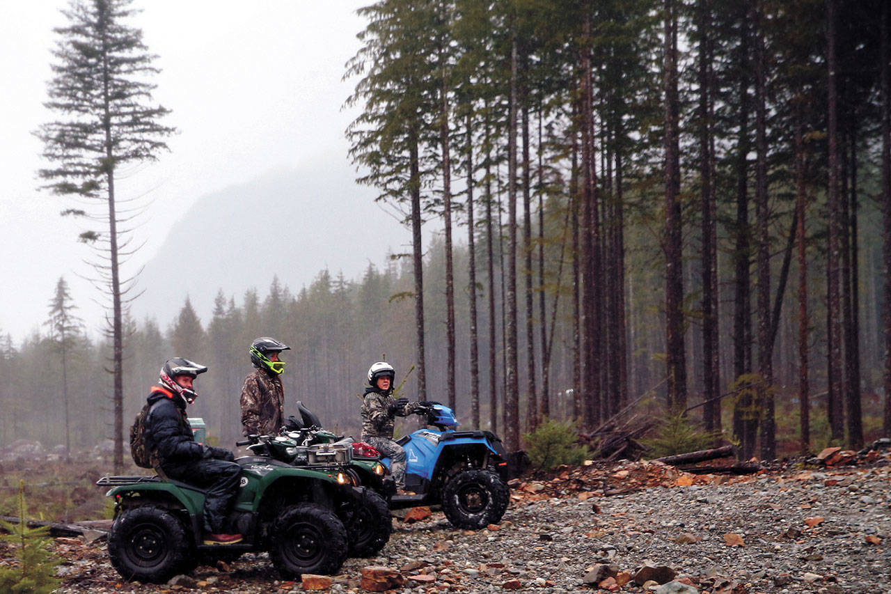 Quitting Henry-Vega, Candace Wiebe and Norma Vasquez take a break during a tour via Index-based Chinook ATV’s Expeditions through the Reiter Foothills Forest. (Kevin Clark / Herald file)