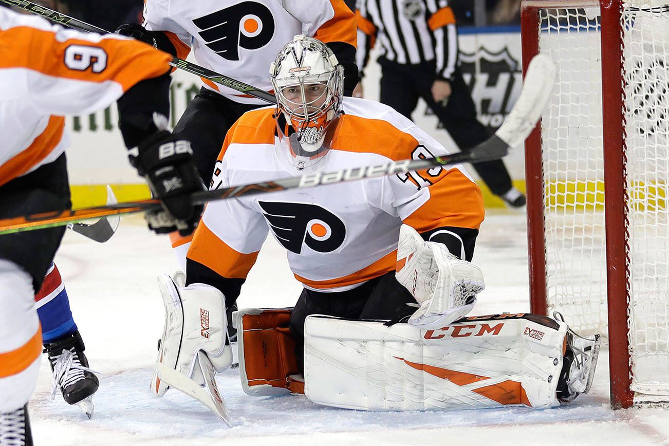 Former Everett Silvertips star goaltender Carter Hart and the rest of the Philadelphia Flyers are one of the 24 NHL teams set to resume playing at one of two hub locations beginning in July. (AP Photo/Seth Wenig)