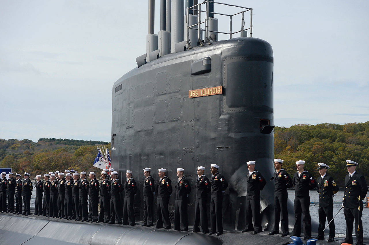 This 2016 photo shows the commissioning of the attack submarine USS Illinois as sailors stand atop the sub in Groton, Connecticut. (AP Photo/Jessica Hill, File)