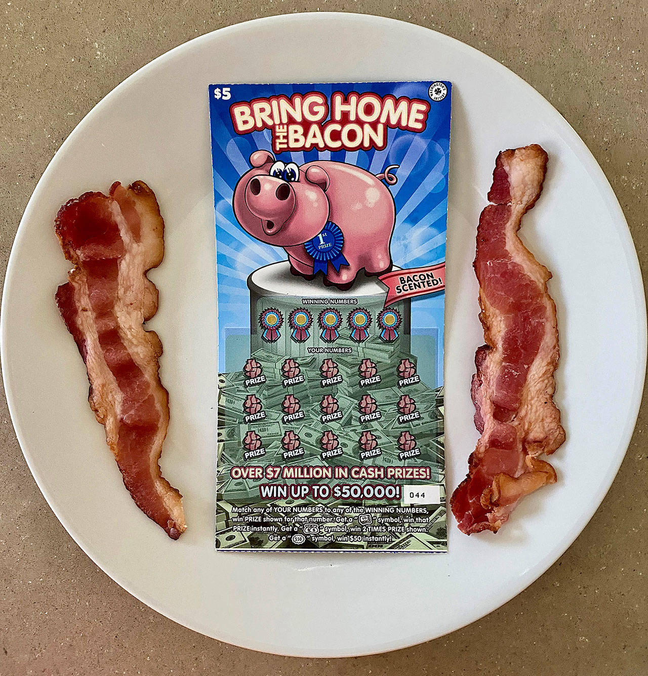 Bring Home the Bacon is a new $5 bacon-scented scratch ticket by Washington’s Lottery. (Andrea Brown / The Herald )
