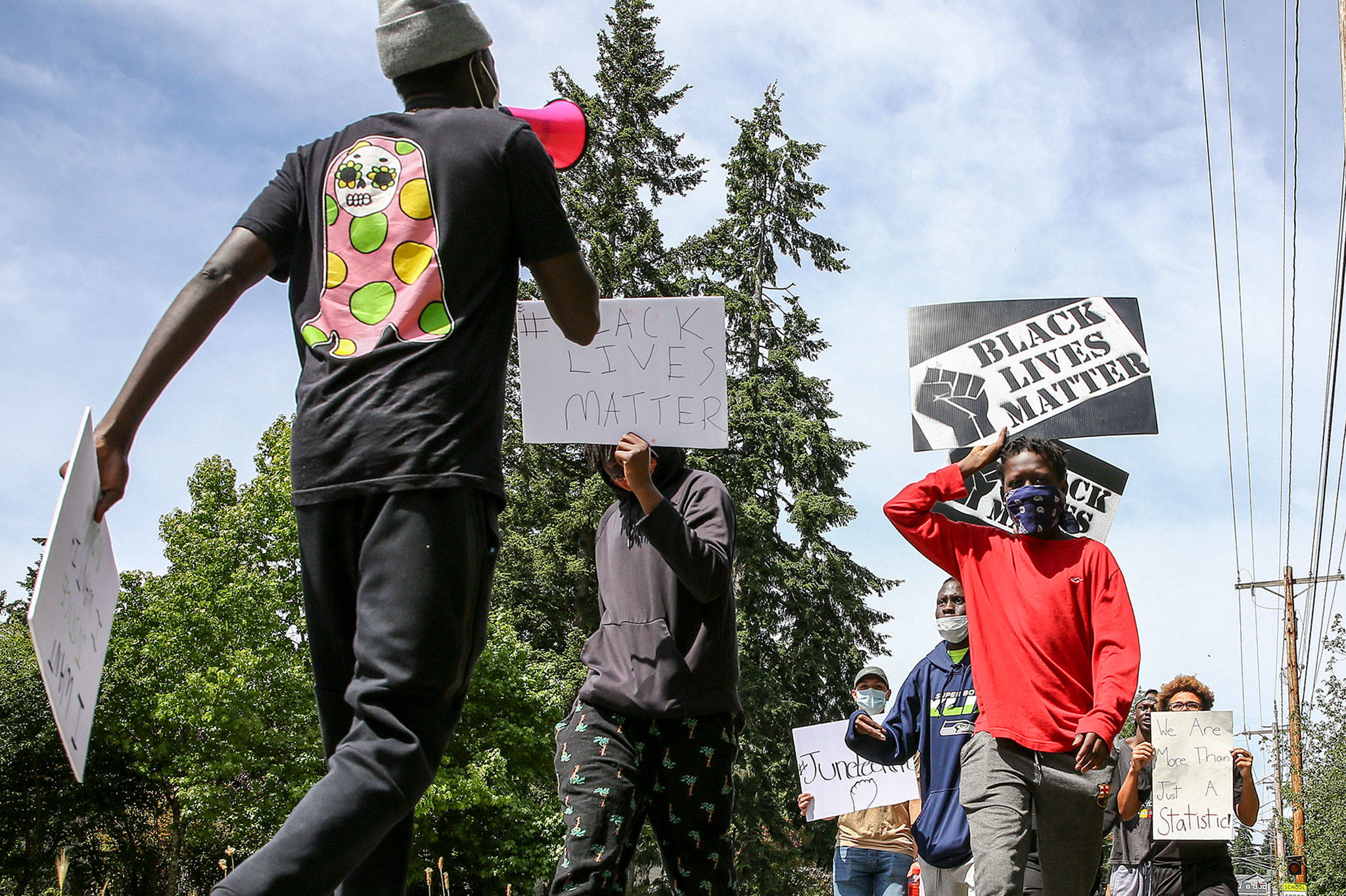 Hundreds of marchers took part in a Juneteenth Black Lives Matter march from College Place Middle School to the Edmonds School District headquarters Friday in Lynnwood. (Kevin Clark / The Herald)