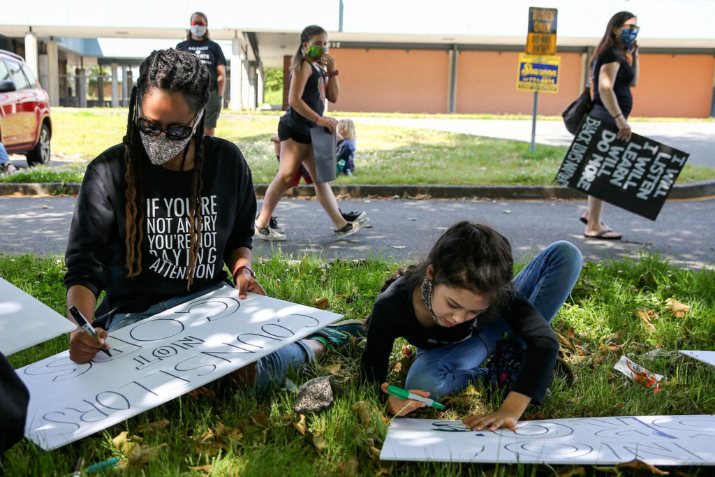 Hundreds of marchers took part in a Juneteenth Black Lives Matter march from College Place Middle School to the Edmonds School District headquarters Friday in Lynnwood. (Kevin Clark / The Herald)
