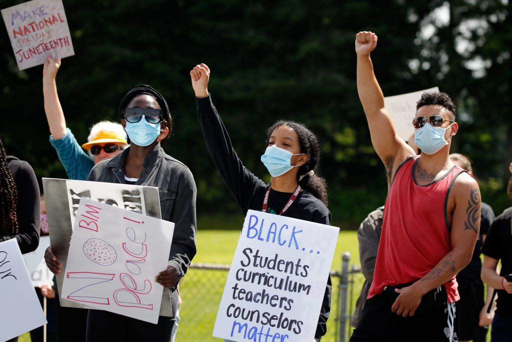 Hundreds of marchers took part in a Juneteenth Black Lives Matter march from College Place Middle School to the Edmonds School District headquarters Friday in Lynnwood. (Kevin Clark / The Herald)
