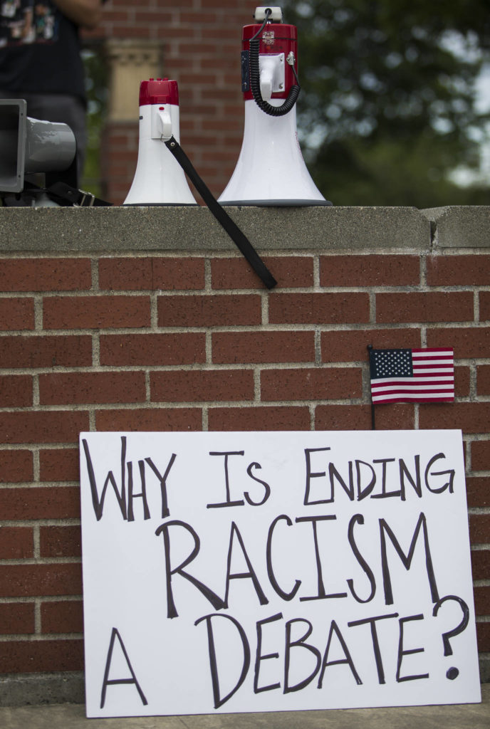 A sign is discarded after the end of the Juneteenth protest on Friday, June 19, 2020 in Snohomish, Wa. (Olivia Vanni / The Herald)
