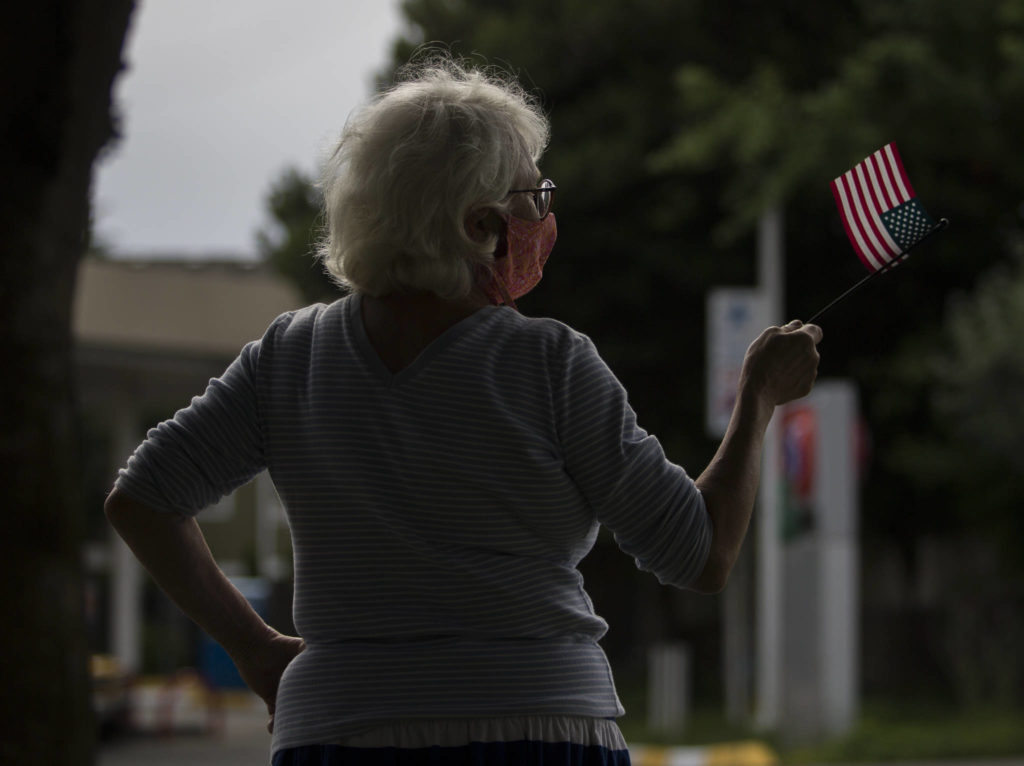 Andrea Moore waves a flag in support of protesters on Friday, June 19, 2020 in Snohomish, Wa. (Olivia Vanni / The Herald)
