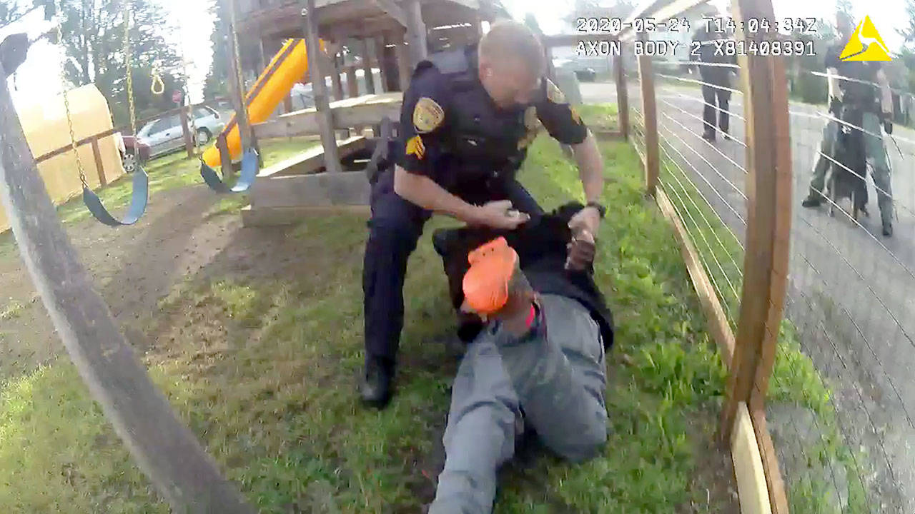 As seen in body-camera video, an Everett police sergeant places handcuffs on Joseph Michael Hill, 39, while kneeling on his back. Everett’s chief says it was reasonable use of force. Hill’s attorney disagrees. (Everett Police Department)