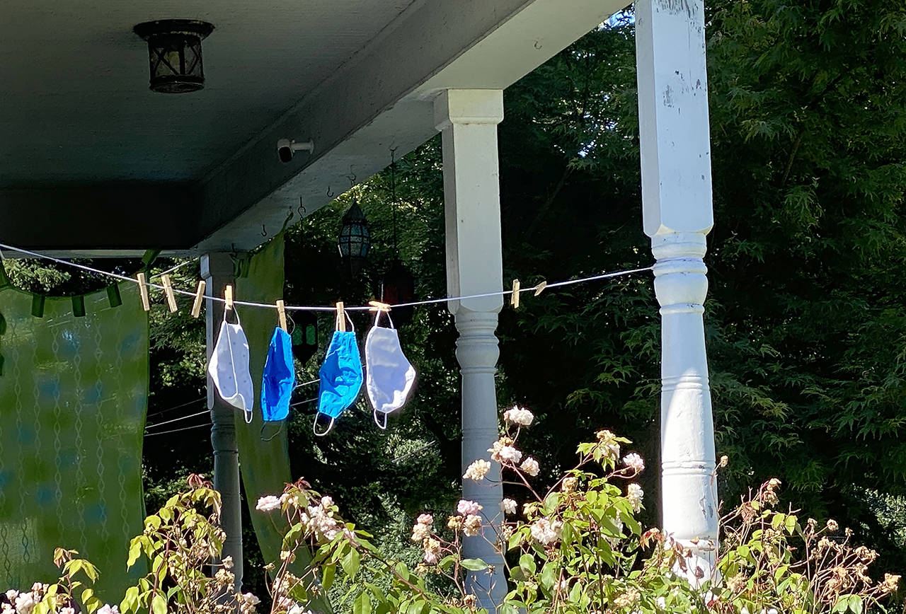 Face masks hang out to dry on the porch of a Rucker Hill-area home in Everett on Monday. (Sue Misao / The Herald)