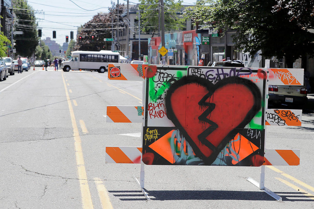 A broken heart is painted on a street barricade near one of the entrances to what has been named the Capitol Hill Occupied Protest zone in Seattle on Monday. (AP Photo/Ted S. Warren)
