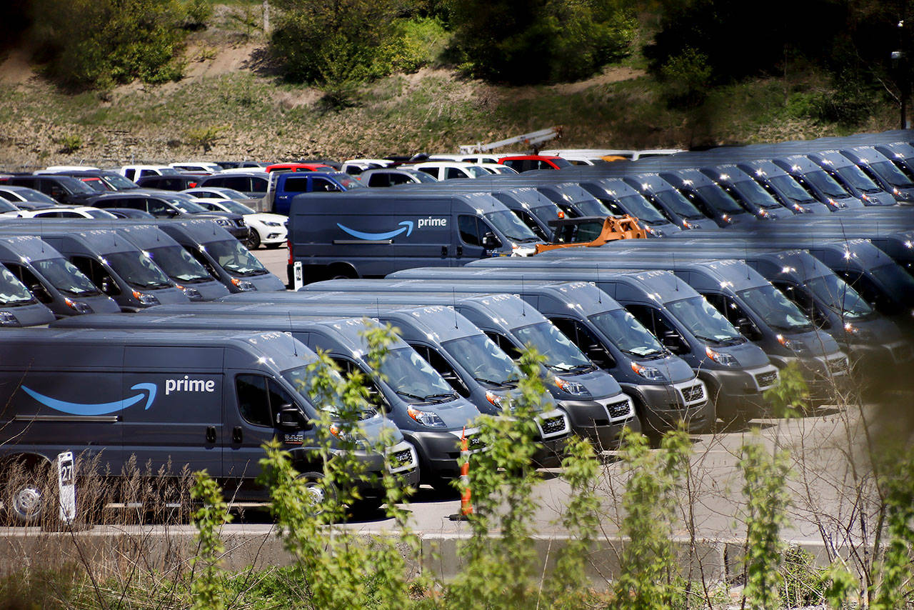 Rows of Amazon Prime delivery vans are stored in the lots at the Cox Automotive Inc. Manheim Pittsburgh vehicle auctioning location in Cranberry Township, Pennsylvania, on May 13. (AP Photo/Keith Srakocic, file)