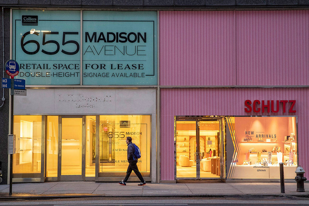 In this March 19 photo, a pedestrian walks past a storefront for rent on Madison Avenue, in New York. (AP Photo/Mary Altaffer, File)
