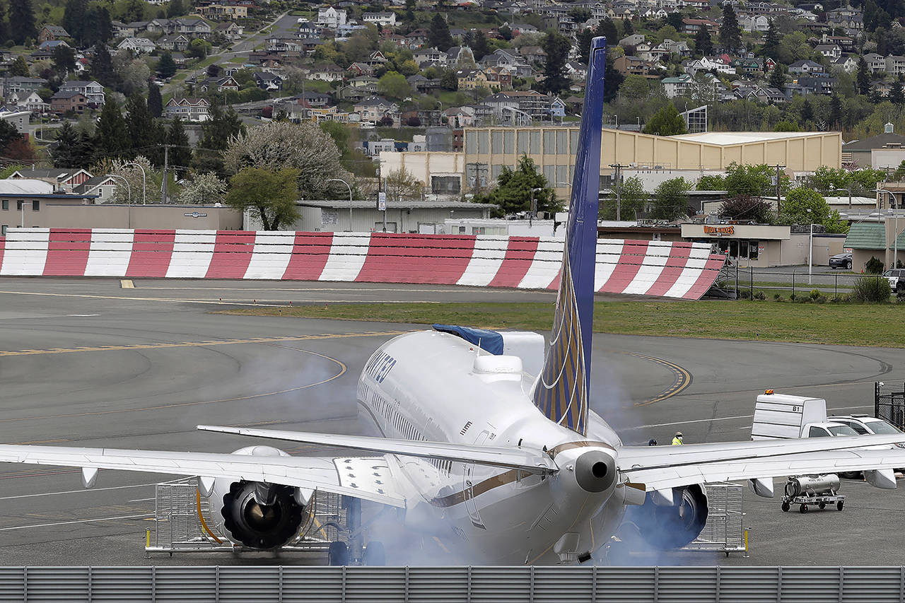 Routine smoke is seen as the engines on a Boeing 737 Max airplane owned by United Airlines are started April 21 in Renton. (AP Photo/Ted S. Warren, file)